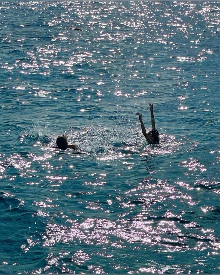 Two swimmers held in a field of sparkling Mediterranean blue