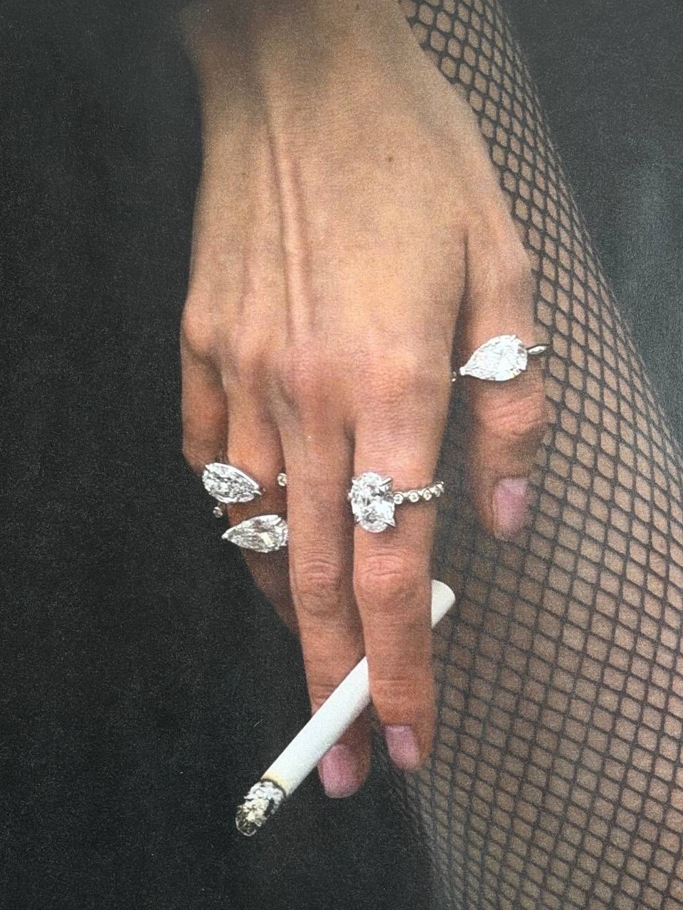 Diamond rings styled against black fishnet tights